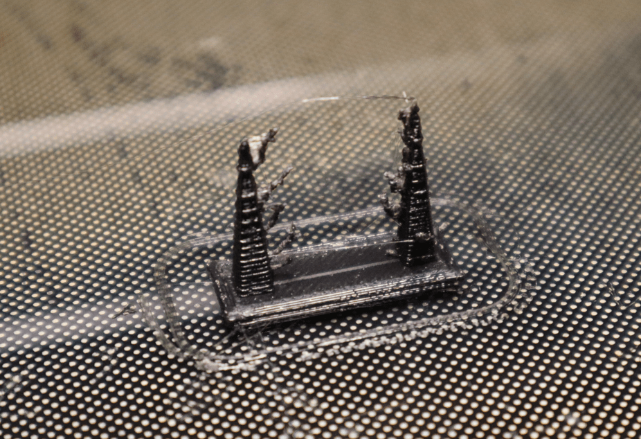 A test print displaying stringing that occured as the hotend traveled from pillar to pillar.