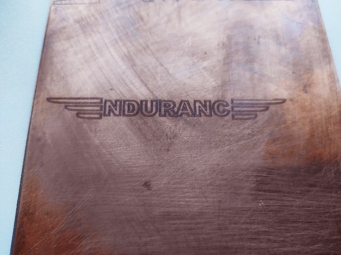 An engraving on a copper plate created by an Endurance laser